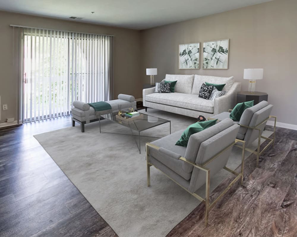 Model living room with wood-style flooring at Northampton Apartment Homes in Largo, Maryland
