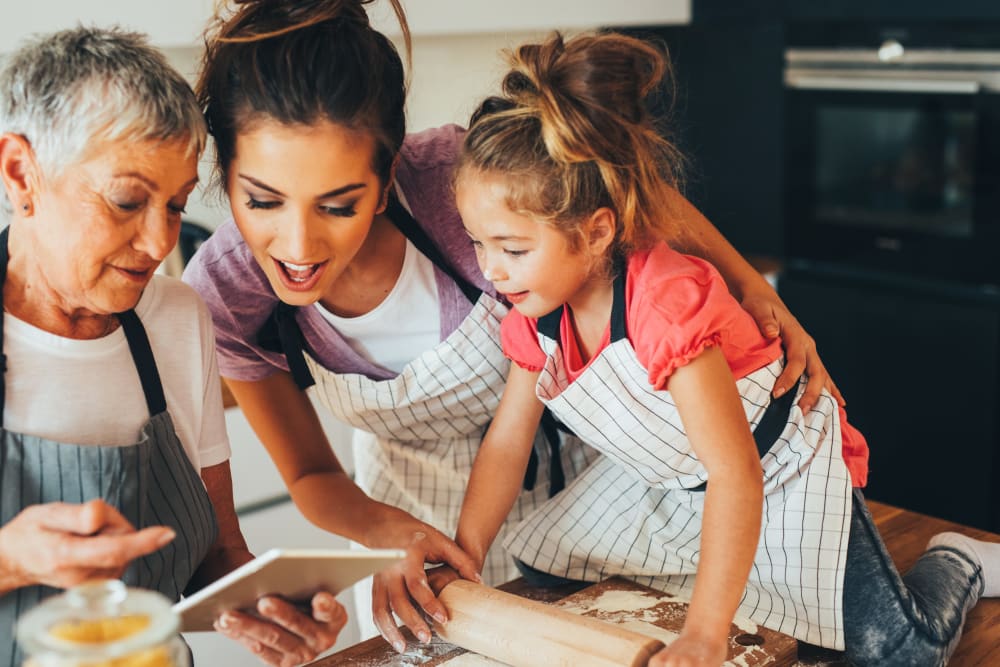 Family cooking together in their fully equipped modern kitchen at Maiden Bridge & Canongate Apartments in Pittsburgh, Pennsylvania