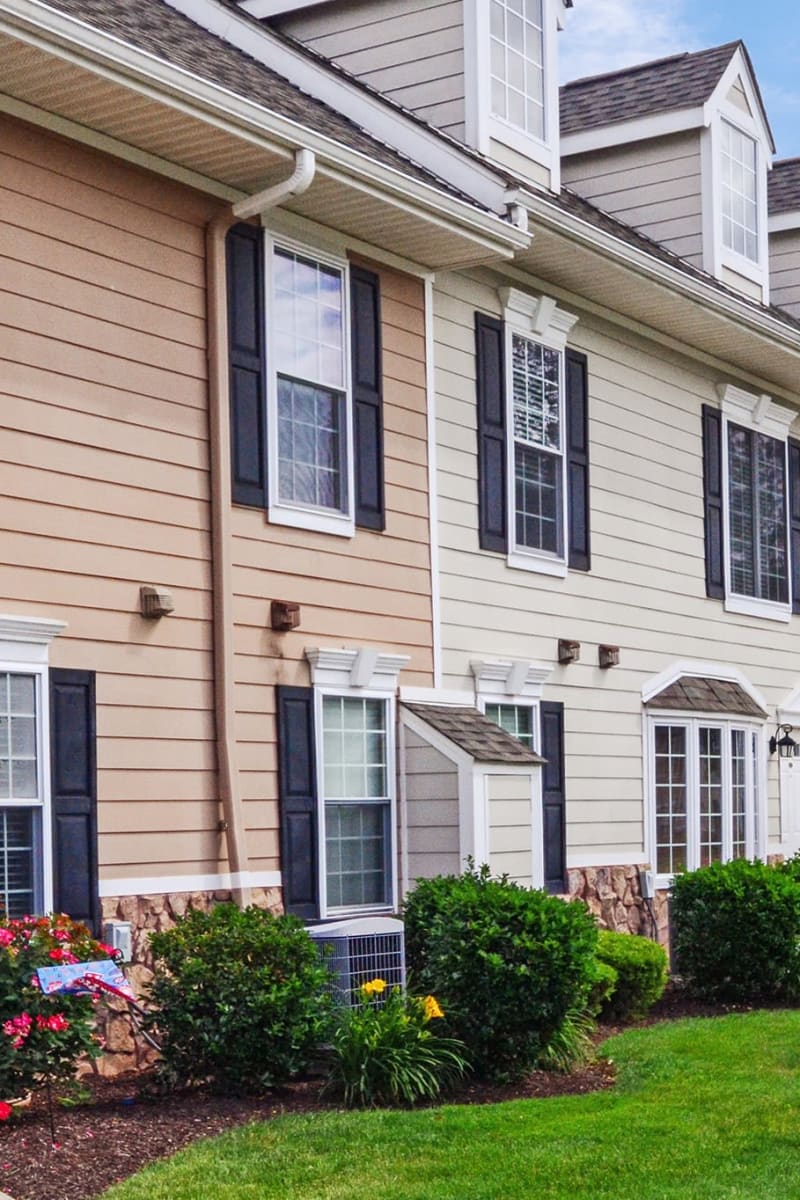 Exterior of Montgomery Manor Apartments & Townhomes on a sunny spring day in Hatfield, Pennsylvania