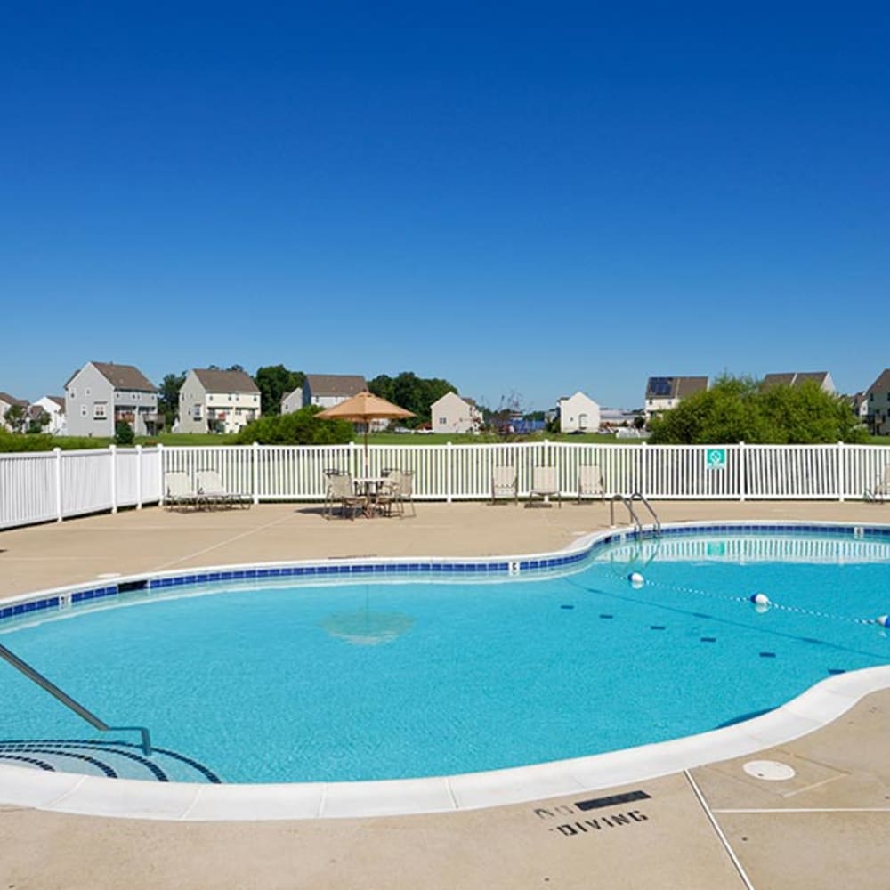 Swimming pool surrounded by lounge chairs at Cannon & Westover in Dover, Delaware