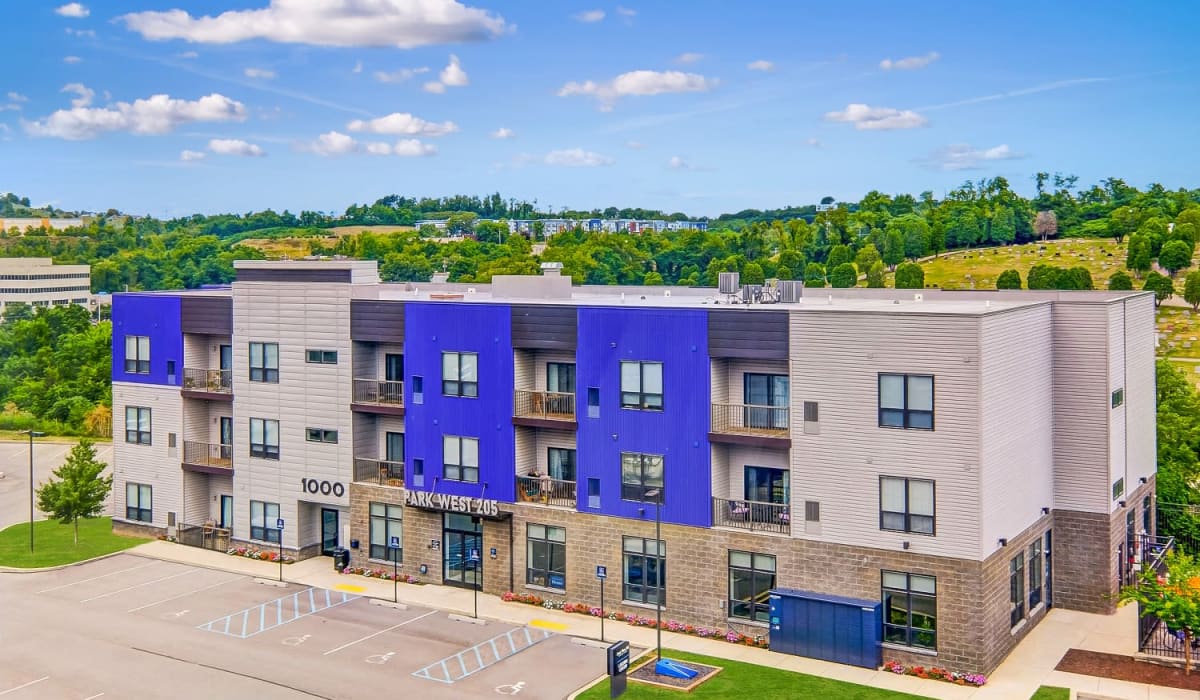 View of exterior of apartments and green lawn at Park West 205 Apartment Homes apartments in Pittsburgh, Pennsylvania