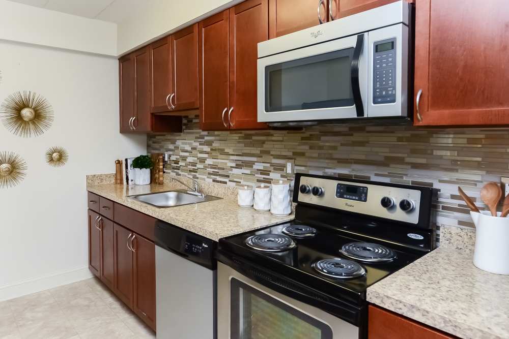 Contemporary kitchen with stainless-steel appliances at Stonegate at Devon Apartments in Devon, Pennsylvania