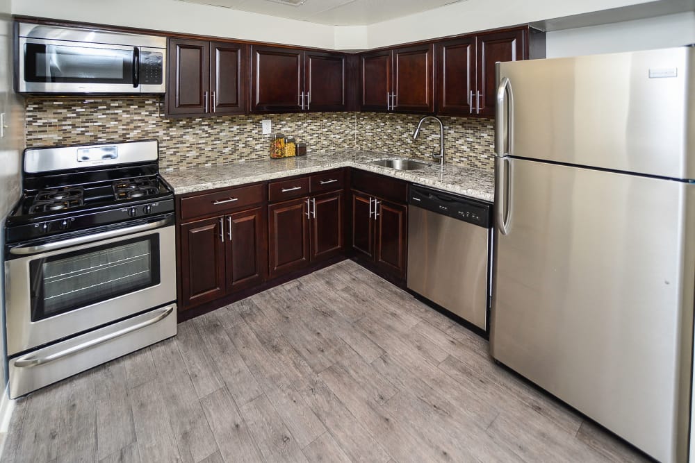 Kitchen with espresso cabinets and stainless appliances at apartments in Harleysville, Pennsylvania