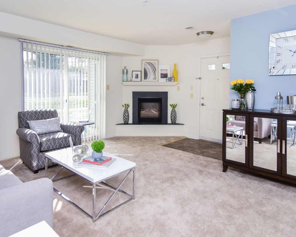 Spacious living room with a gas fireplace at Abrams Run Apartment Homes in King of Prussia, Pennsylvania