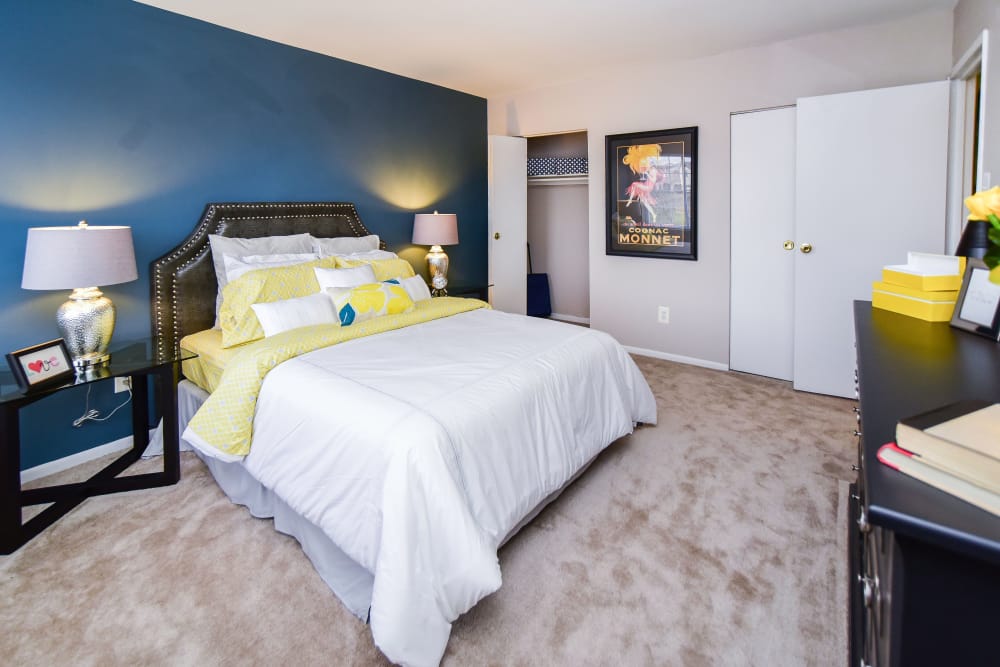 Carpeted bedroom with dresser at Montgomery Woods Townhomes in Harleysville, Pennsylvania