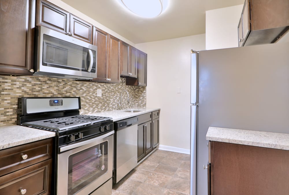 Modern kitchen with new appliances at Gwynn Oaks Landing Apartments & Townhomes in Baltimore, Maryland