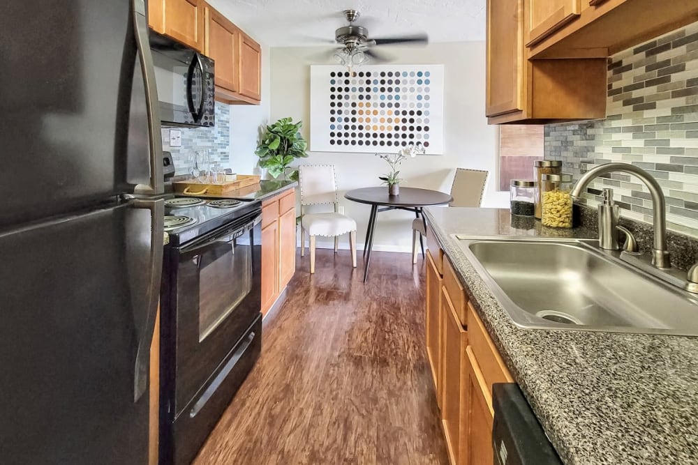 Kitchen with stainless steel appliances at Solon Club Apartments in Oakwood Village, Ohio