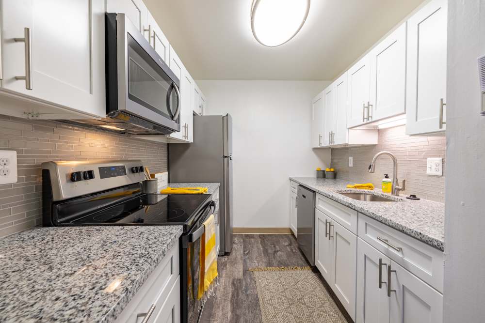 Fully-Equipped Kicthen with White Cabinetry at Squires Manor Apartment Homes in South Park, Pennsylvania