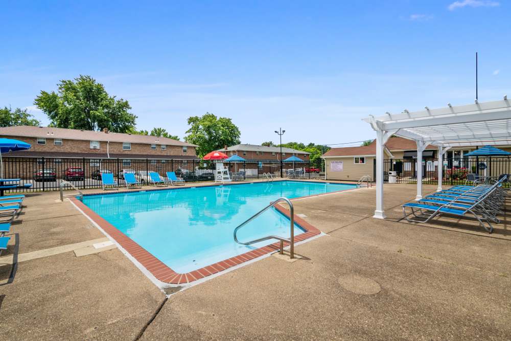 Swimming pool surrounded by lounge chairs at Burnt Mill Apartment Homes in Voorhees, New Jersey