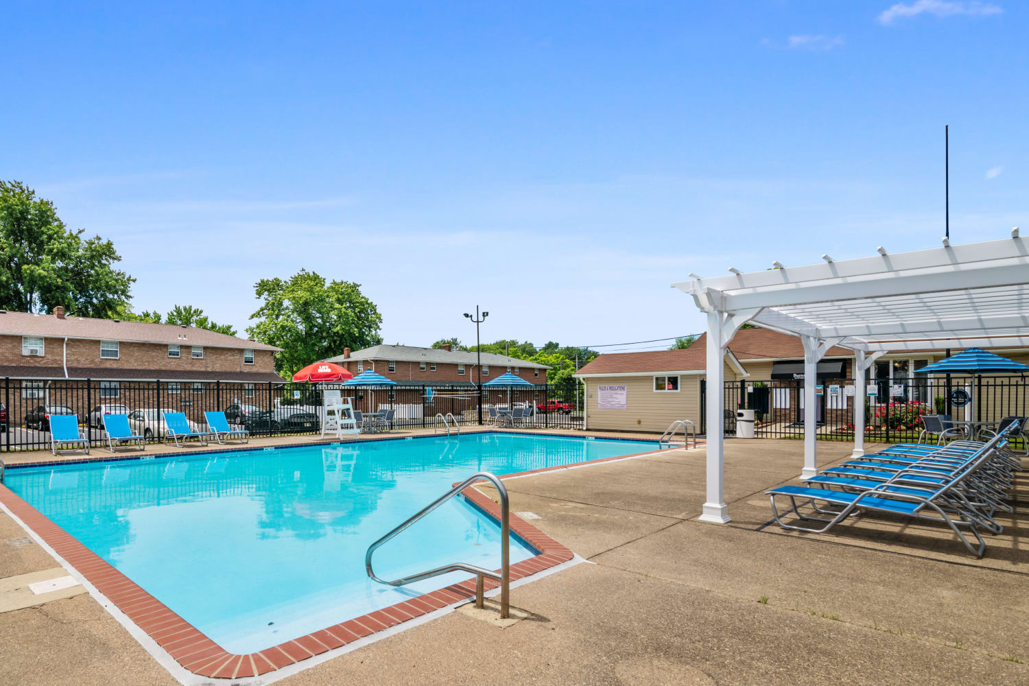 Swimming pool surrounded by lounge chairs at Burnt Mill Apartment Homes in Voorhees, New Jersey