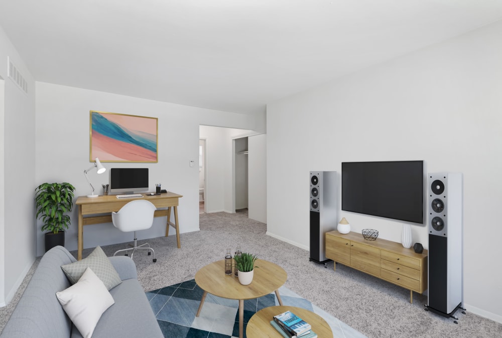 Living room with tv and desk at Burnt Mill Apartment Homes in Voorhees, New Jersey