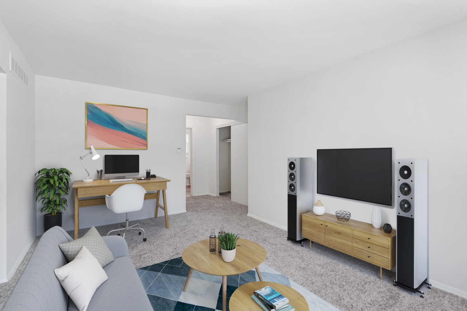 Living room with television, entertainment system, and study table at Burnt Mill Apartment Homes in Voorhees, New Jersey