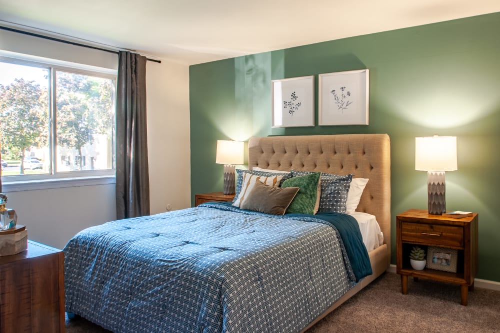 Stylish Bedroom with Quilted Headboard at Chesterfield Apartment Homes in Levittown, Pennsylvania