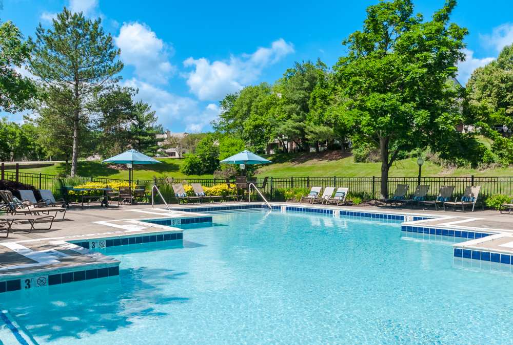 Pool with tables and umbrellas surround at Club at North Hills in Pittsburgh, Pennsylvania
