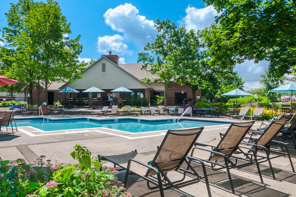 Pool with tables and umbrellas surrounding at Club at North Hills in Pittsburgh, Pennsylvania