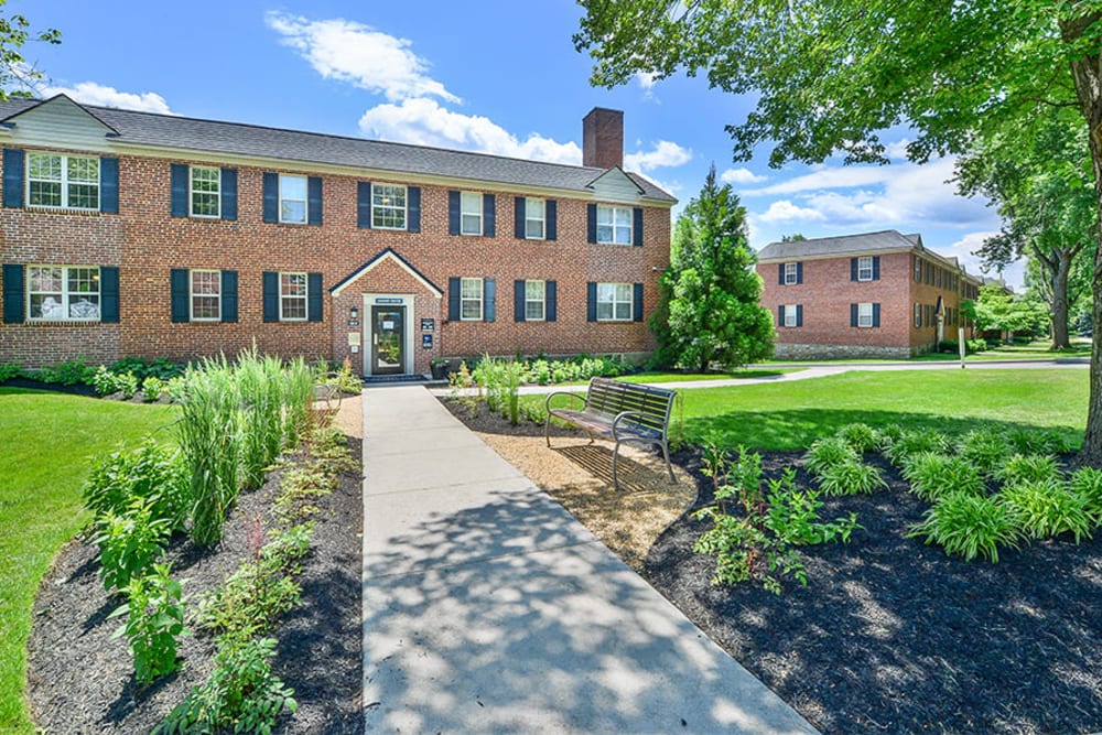 Building exterior with meticulous landscaping at The Villas at Bryn Mawr Apartment Homes in Bryn Mawr, Pennsylvania