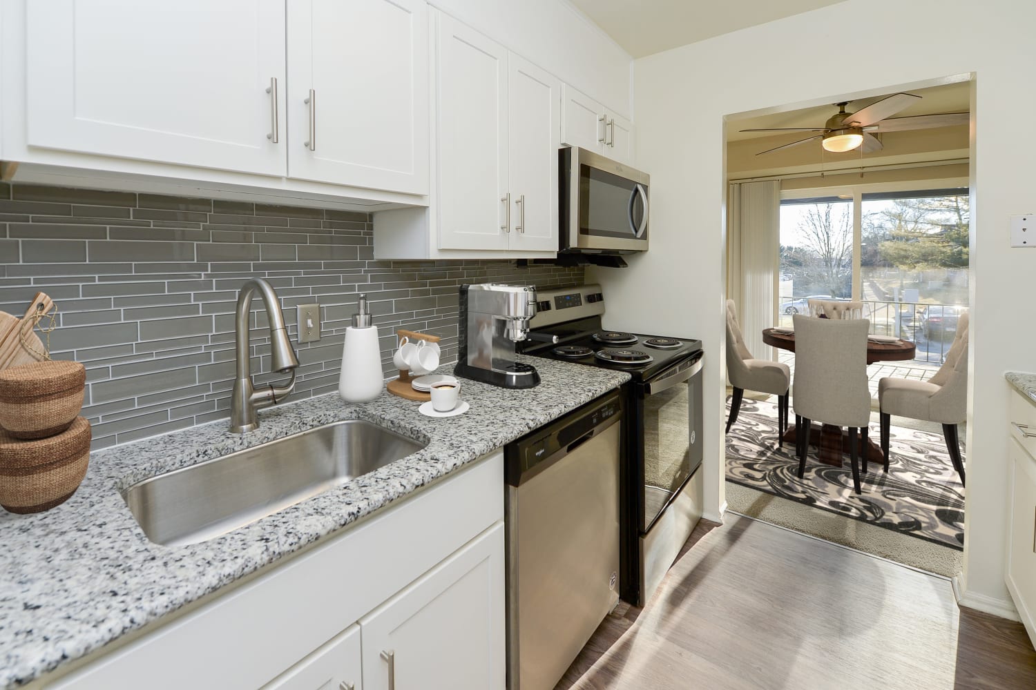 Kitchen with white cabinetry and tile backsplash at King's Manor Apartments in Harrisburg, Pennsylvania