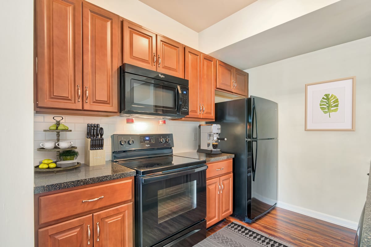 Kitchen with Wooden Cabinetry at The Village of Laurel Ridge & The Encore Apartments & Townhomes in Harrisburg, Pennsylvania