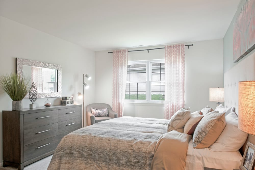 Natural-lit bedroom with plush carpeting at Forge Gate Apartment Homes in Lansdale, Pennsylvania