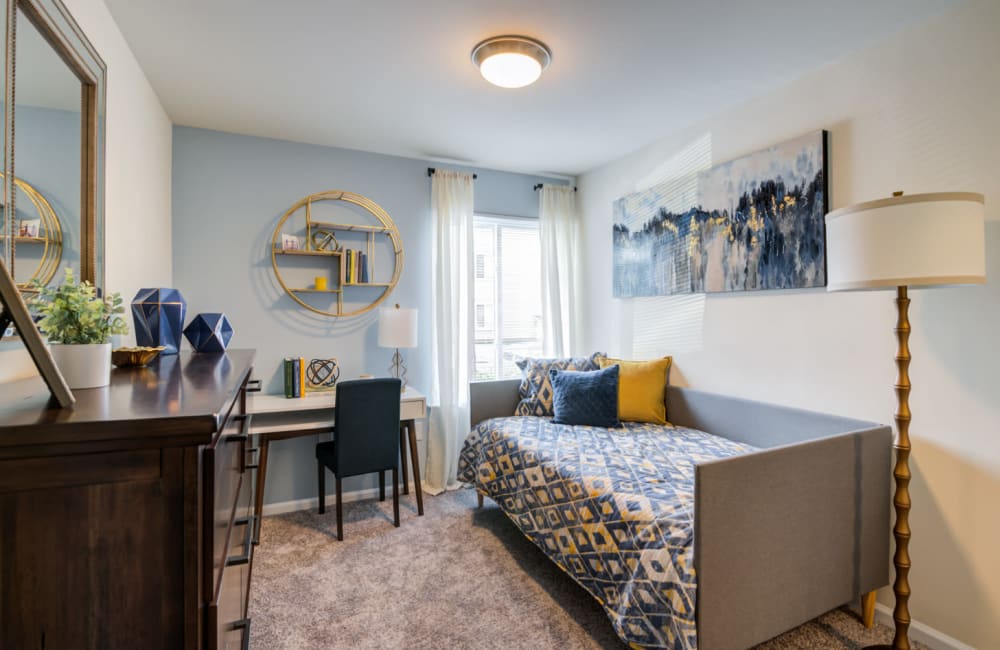 Bedroom staged with a twin daybed, dresser, and desk at Fox Run Apartments & Townhomes in Bear, Delaware