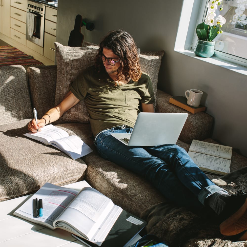 Resident studying in his sunny living room at The Villas at Bryn Mawr Apartment Homes in Bryn Mawr, Pennsylvania