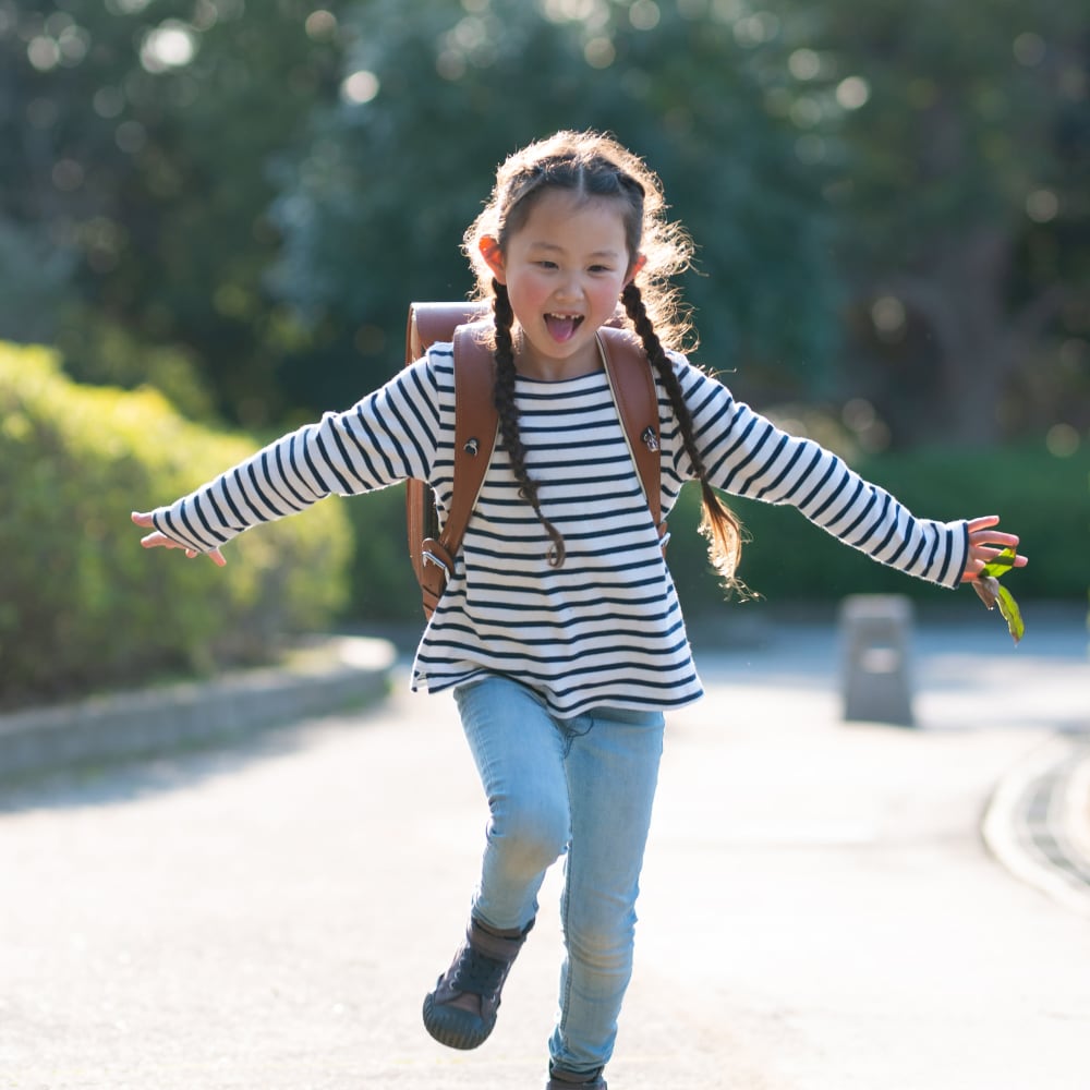 Young resident walking home from school to Chesterfield Apartment Homes in Levittown, Pennsylvania