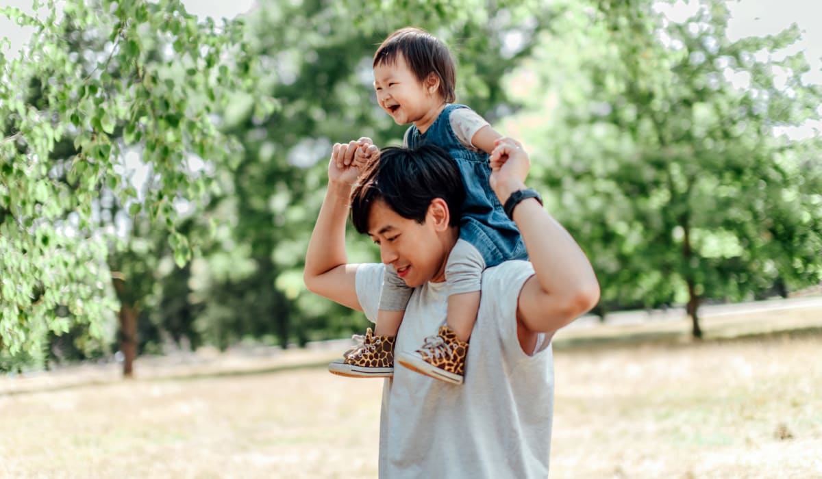 Resident father carrying his daughter on his shoulders at a park near Park West 205 Apartment Homes in Pittsburgh, Pennsylvania