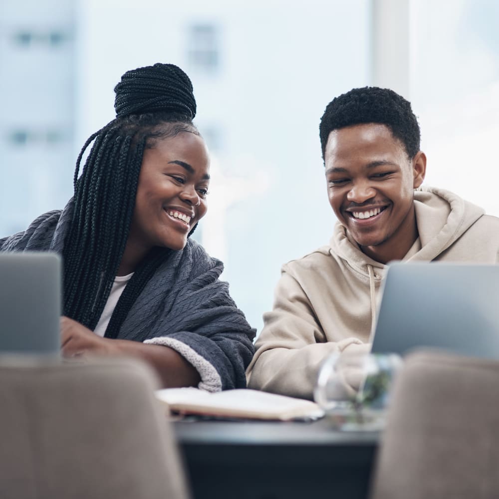 Future residents checking out photos of Oxford Manor Apartments & Townhomes on their laptops in Mechanicsburg, Pennsylvania