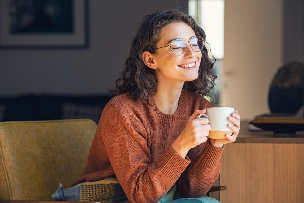 Resident relaxing with a cup of tea at Briarwood Apartments & Townhomes in State College, Pennsylvania