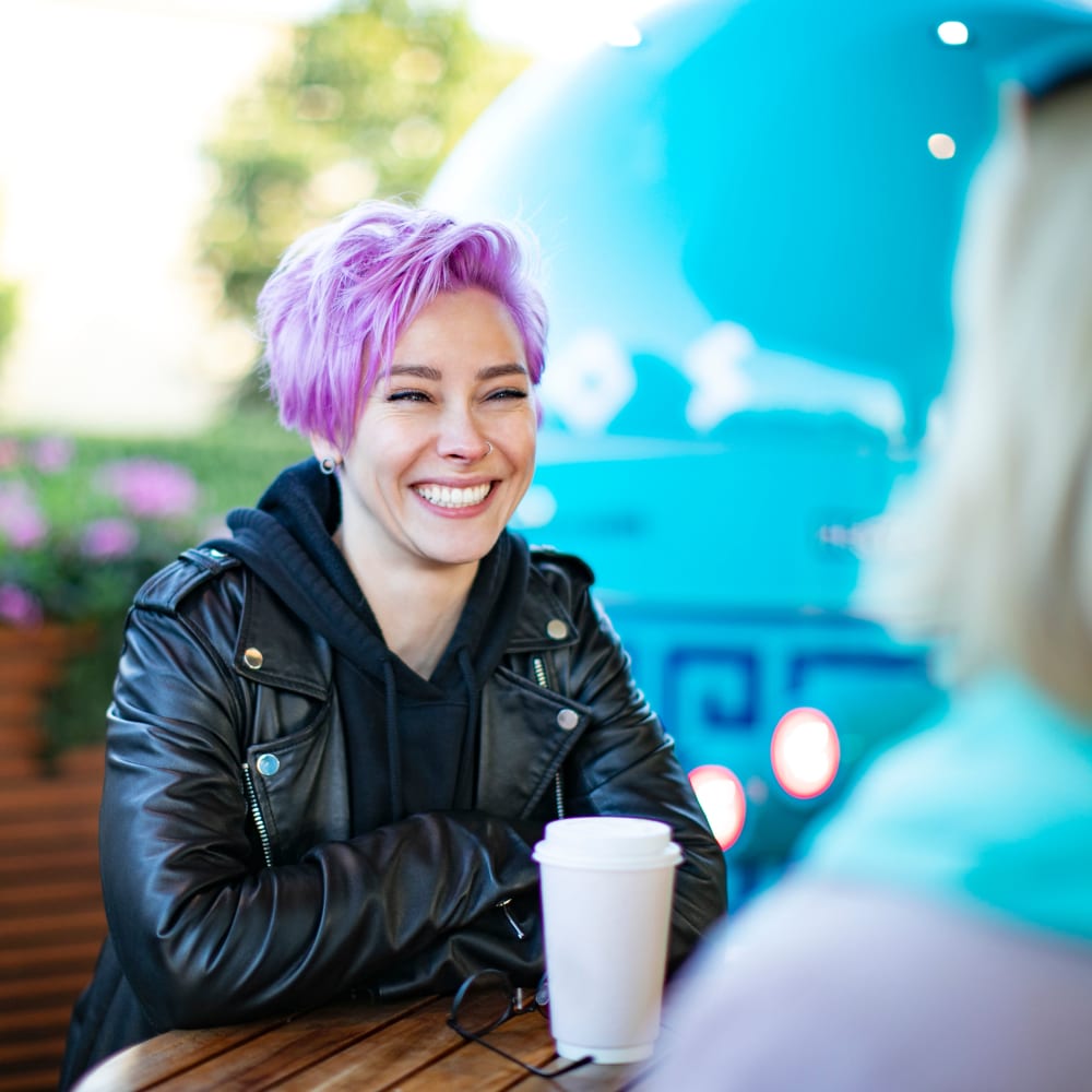 Resident having coffee on the patio of a cafe near Park Place of South Park in South Park, Pennsylvania