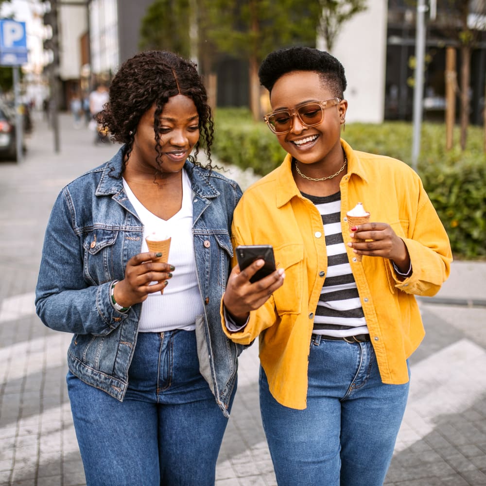 Residents enjoying an ice cream cone on a day out near The Cascades Townhomes and Apartments in Pittsburgh, Pennsylvania