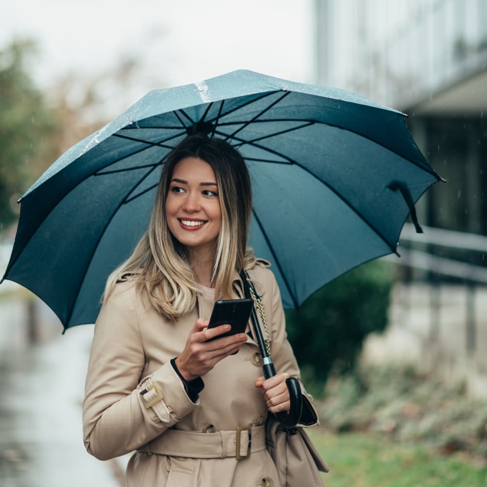 Woman scheduling a tour of Chesterfield Apartment Homes from her phone in Levittown, Pennsylvania