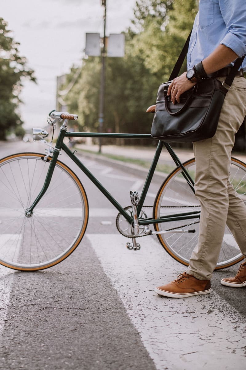 Resident crossing a crosswalk with his bike on his way to work near Montgomery Manor Apartments & Townhomes in Hatfield, Pennsylvania