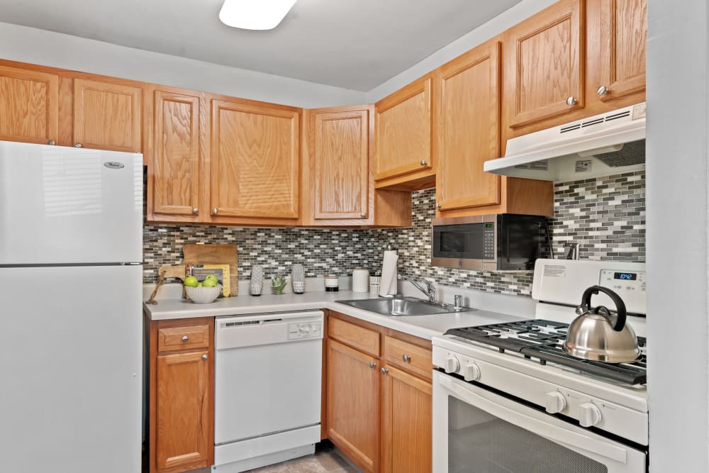 Modern-Style Kitchen with Wooden Cabinetry at Gwynn Oaks Landing Apartments & Townhomes, MD
