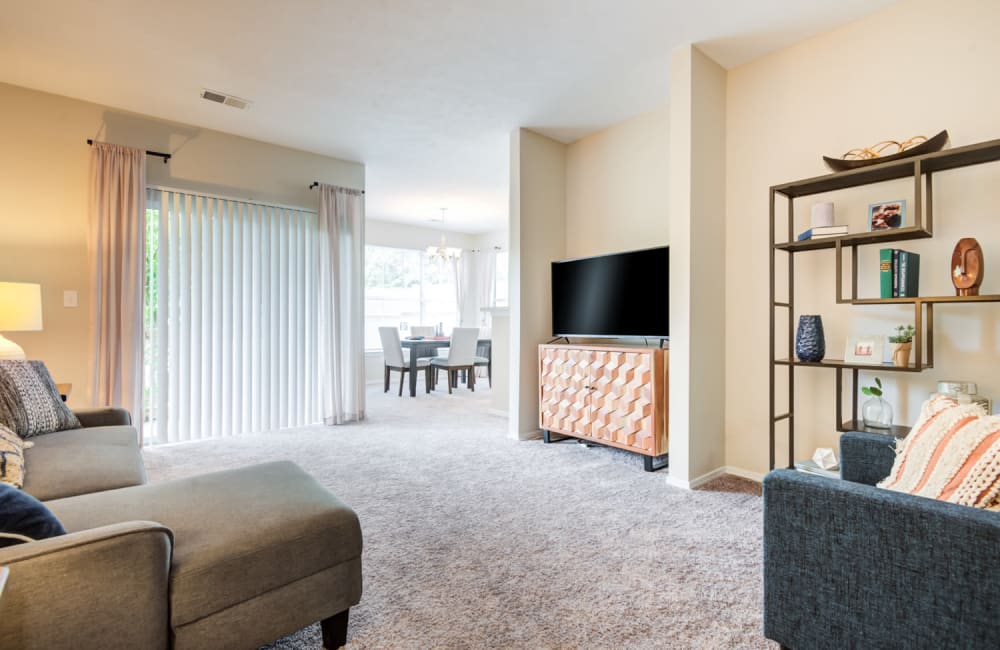 Spacious well lit living room fully furnished with backyard access Highlands of Montour Run in Coraopolis, Pennsylvania