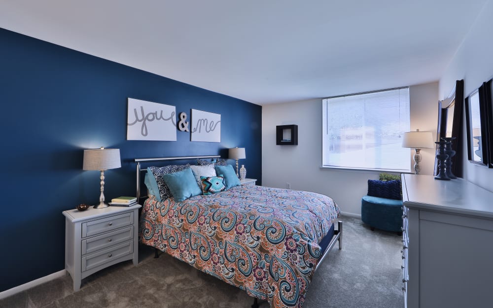 Carpeted Bedroom with Bedside Table at Lakewood Hills Apartments & Townhomes in Harrisburg, Pennsylvania