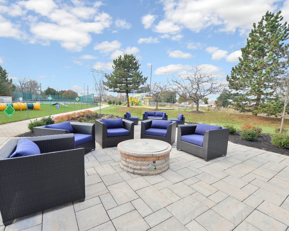 Outdoor lounge area with a fire pit at Abrams Run Apartment Homes in King of Prussia, Pennsylvania