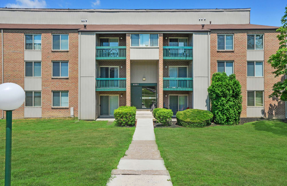 Exterior view with private patio and lush lawn at Lakewood Hills Apartments & Townhomes in Harrisburg, Pennsylvania