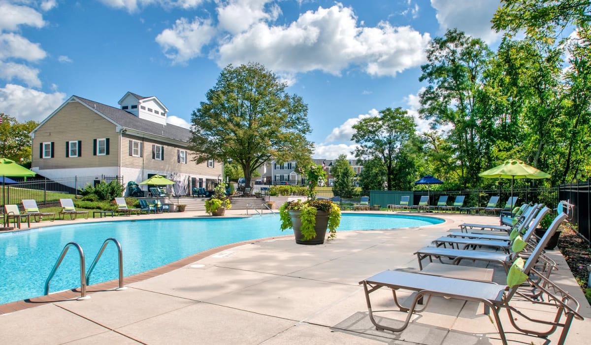 Swimming pool with lounge chairs The Village of Laurel Ridge & The Encore Apartments & Townhomes apartments in Harrisburg, Pennsylvania