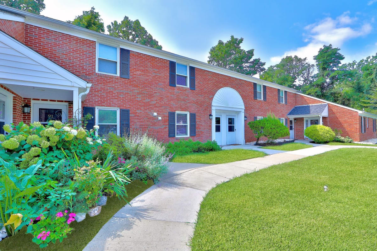 Exterior of Building with Landscaped Garden at The Village of Laurel Ridge & The Encore Apartments & Townhomes in Harrisburg, Pennsylvania