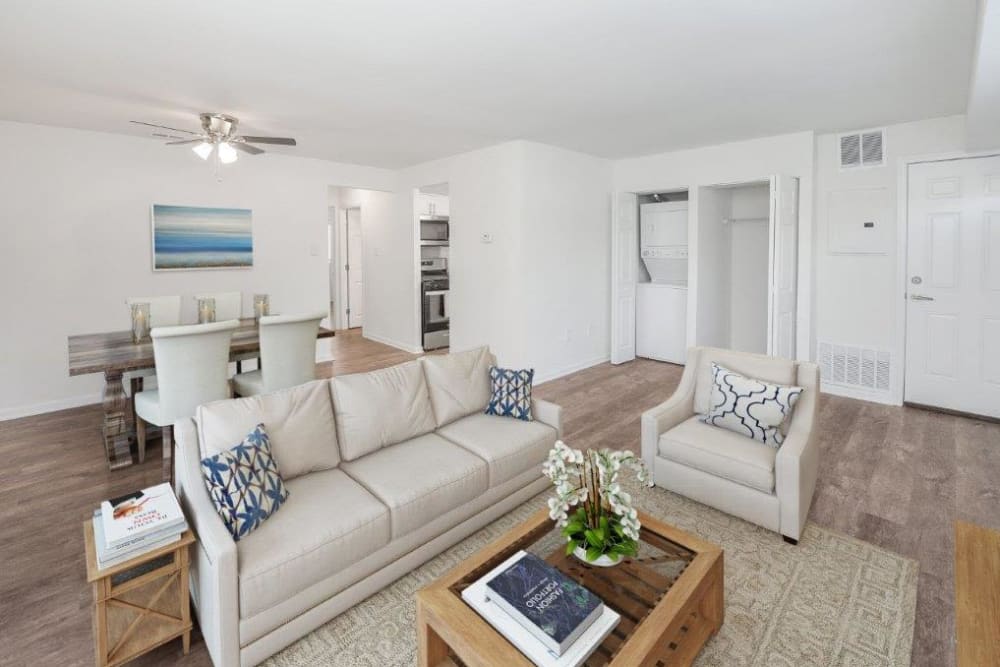 Well-lit dining and living area with vinyl plank flooring at Forge Gate Apartment Homes in Lansdale, Pennsylvania