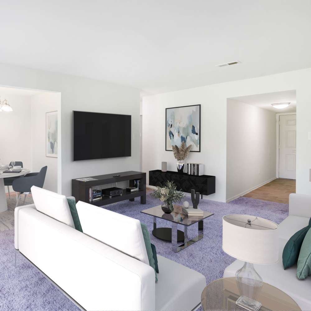 Model living room with plush carpeting at Lumberton Apartment Homes in Lumberton, New Jersey