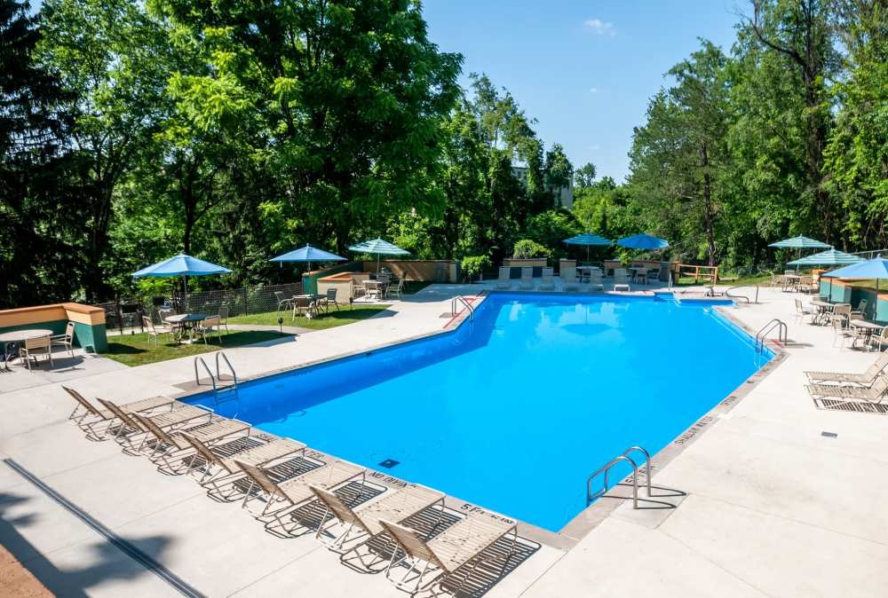 Swimming pool with lounge chairs at Maiden Bridge & Canongate Apartments in Pittsburgh, Pennsylvania