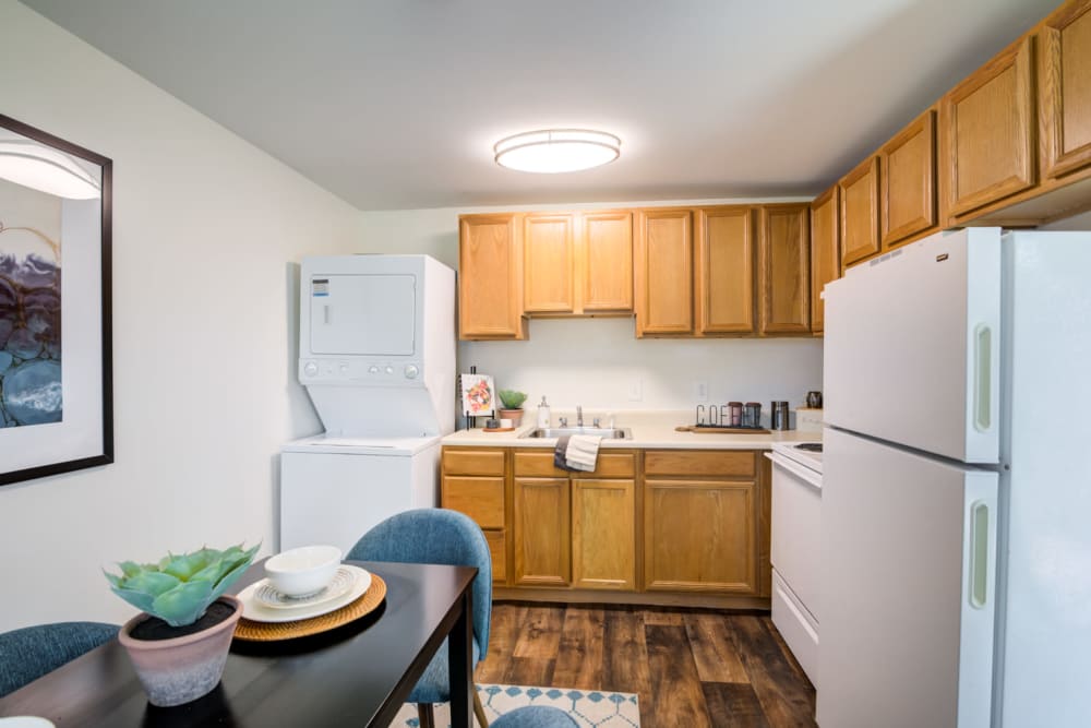 Kitchen with oak cabinets and white appliances next to a dining nook