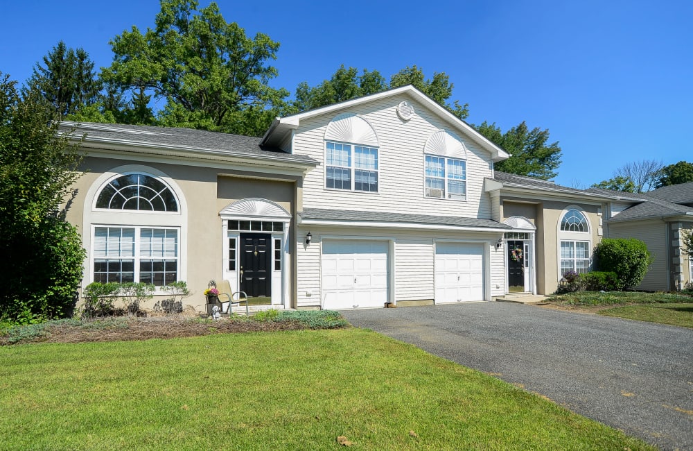 Exterior with lush lawn and two car garage at Mews at Annandale Townhomes in Annandale, New Jersey