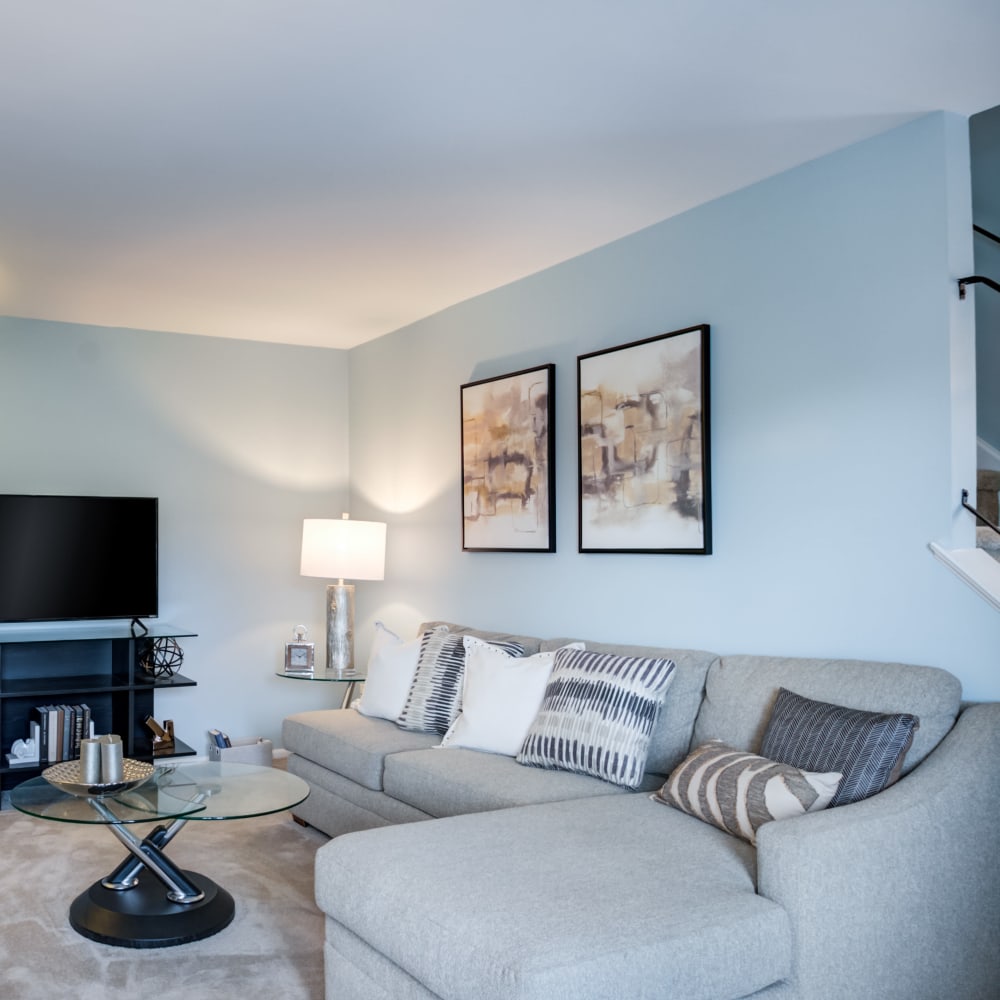 Model living room with wall to wall carpeting at Montgomery Woods Townhomes in Harleysville, Pennsylvania