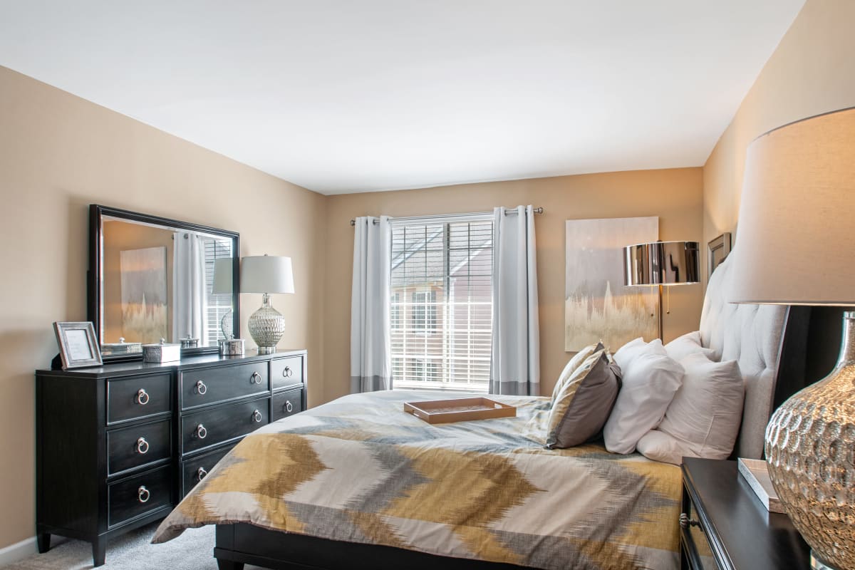 Bedroom with large windows and a dresser at Montgomery Manor Apartments & Townhomes in Hatfield, Pennsylvania