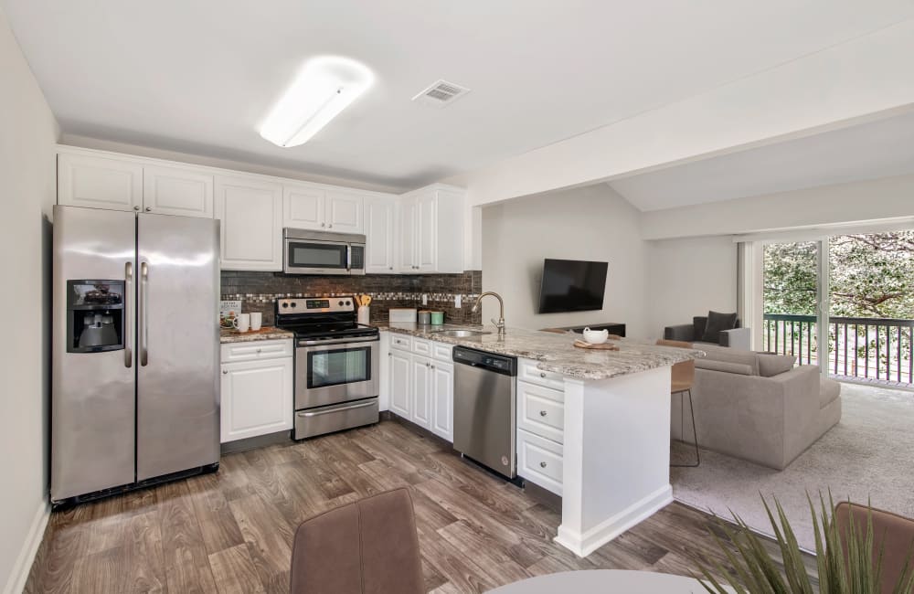 Fully equipped kitchen with white cabinetry and stainless steel appliances at Abrams Run Apartment Homes in King of Prussia, Pennsylvania