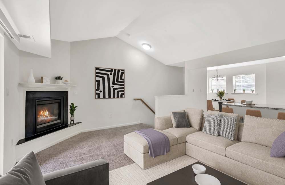 Living room with carpeting in a model home at Abrams Run Apartment Homes in King of Prussia, Pennsylvania