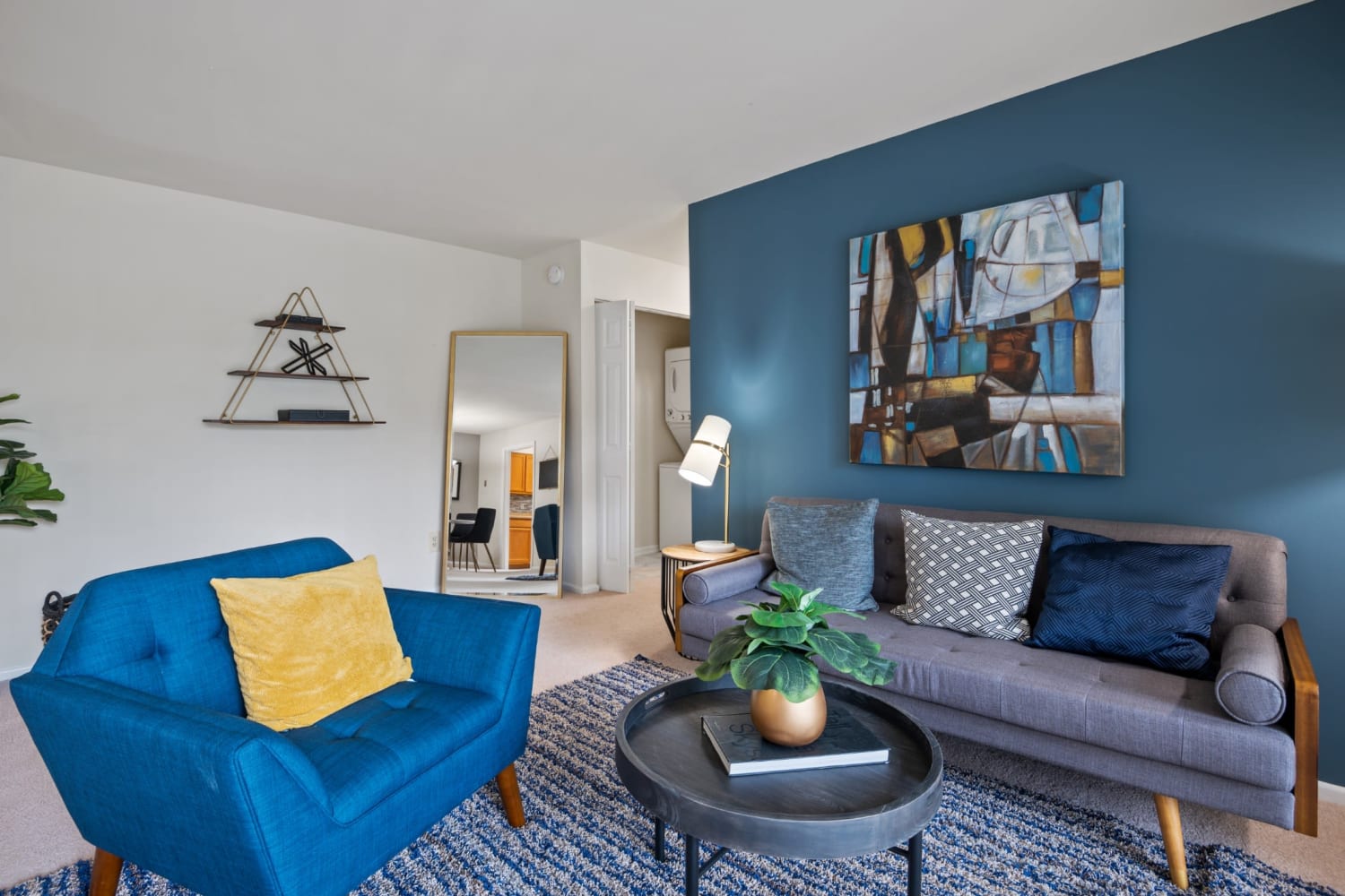 Living room with an accent wall at Mount Vernon Square Apartment Homes in Alexandria, Virginia